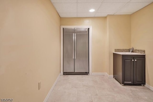 interior space with a sink, baseboards, and recessed lighting