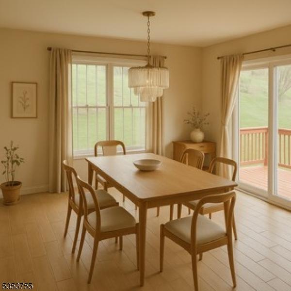 dining area with an inviting chandelier, baseboards, a healthy amount of sunlight, and light wood-type flooring
