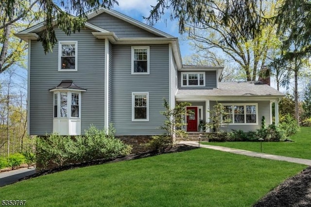 view of front of home featuring a chimney and a front lawn