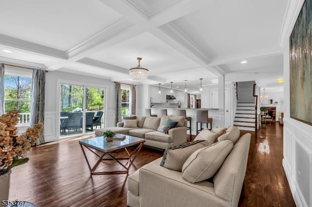 living area with a decorative wall, coffered ceiling, and beam ceiling