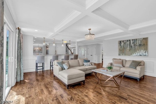 living area featuring crown molding, coffered ceiling, a decorative wall, and beamed ceiling