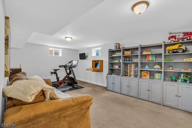 workout area with light colored carpet and baseboards