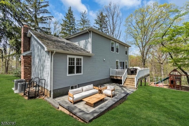 rear view of house with a wooden deck, an outdoor hangout area, a chimney, a playground, and a lawn