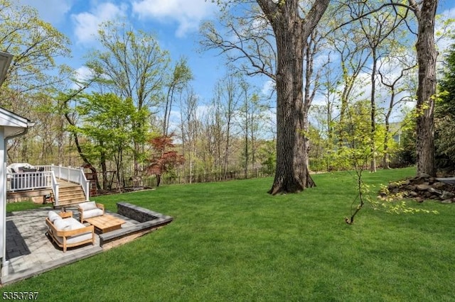 view of yard featuring a patio and a deck