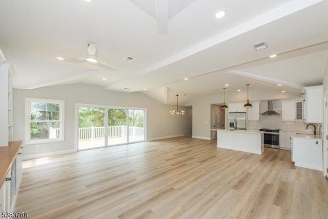 unfurnished living room featuring recessed lighting, a sink, vaulted ceiling with beams, and baseboards