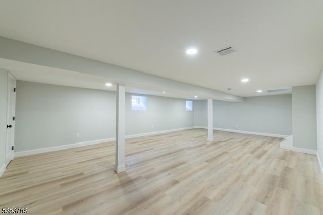 basement with recessed lighting, visible vents, light wood-style flooring, and baseboards
