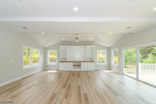 unfurnished living room featuring vaulted ceiling, light wood-style floors, and baseboards