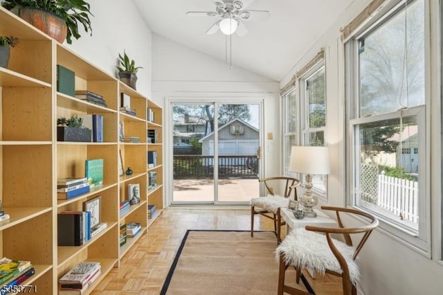 living area with vaulted ceiling and a ceiling fan