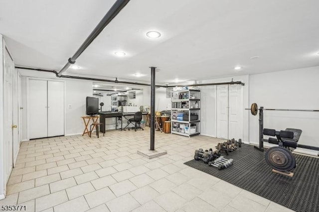 workout area featuring baseboards and recessed lighting