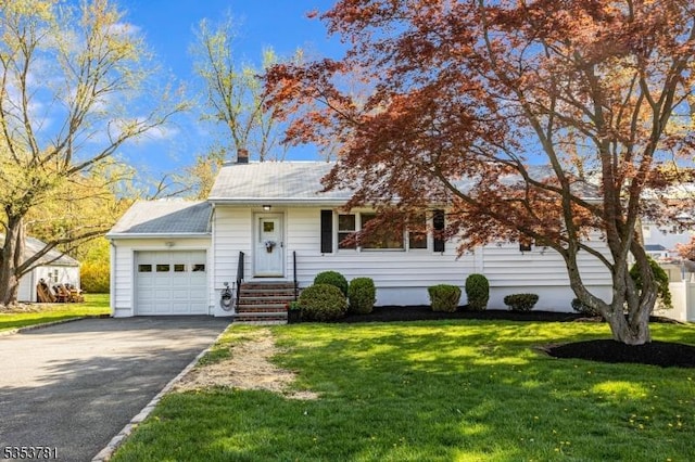 ranch-style house with a front lawn, a chimney, a garage, and aphalt driveway