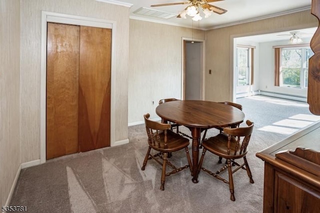 dining room featuring visible vents, ornamental molding, ceiling fan, and light colored carpet