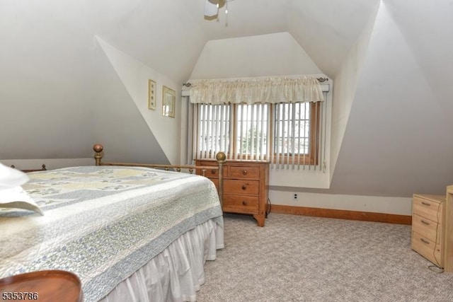 bedroom featuring baseboards, light carpet, a ceiling fan, and lofted ceiling
