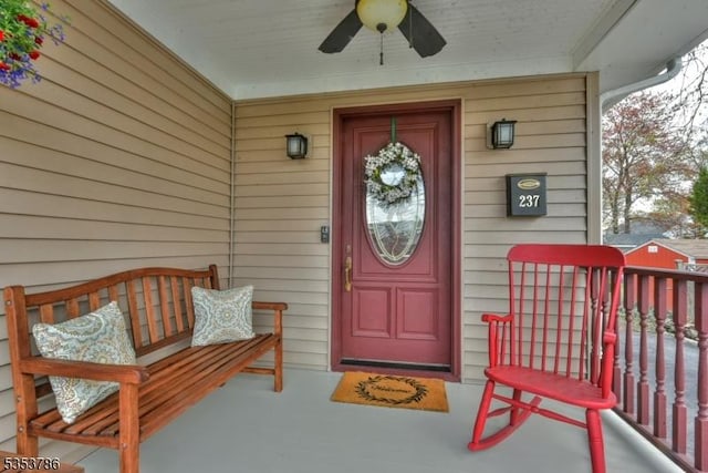 property entrance with ceiling fan and a porch
