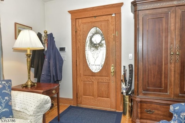 entryway featuring baseboards and wood finished floors