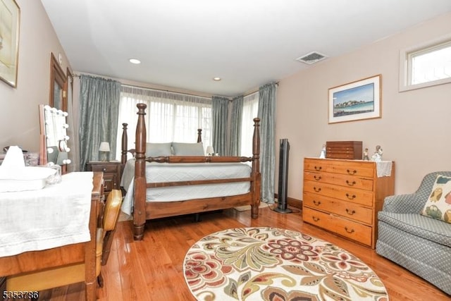 bedroom with recessed lighting, wood finished floors, and visible vents