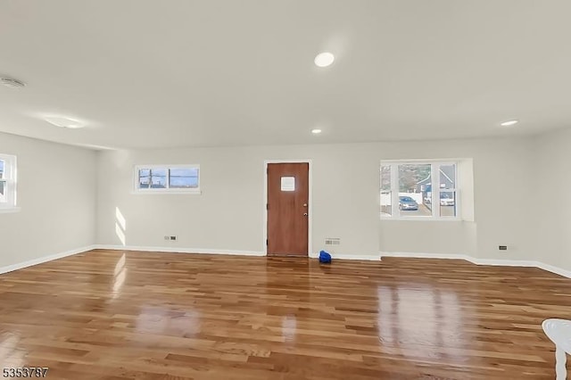 basement featuring baseboards, recessed lighting, and wood finished floors