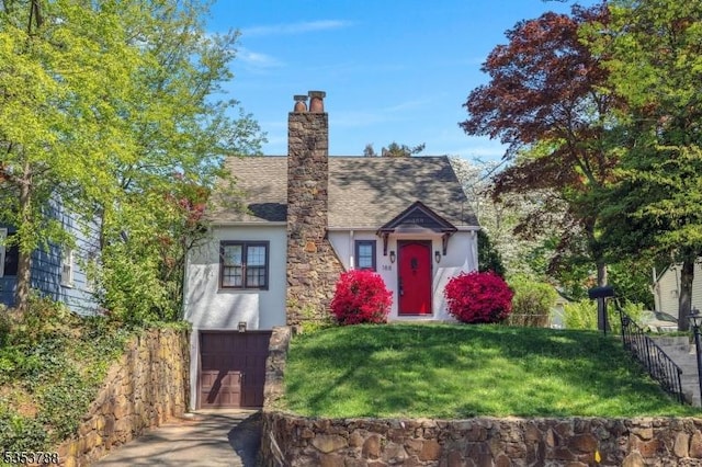 view of front of home featuring driveway, a front yard, fence, an attached garage, and stucco siding