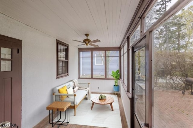 sunroom / solarium featuring baseboards and wooden ceiling