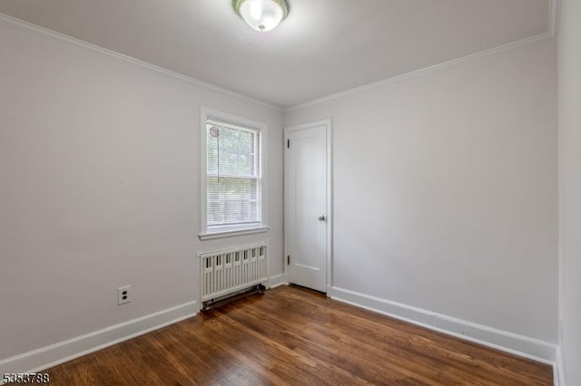 empty room featuring crown molding, baseboards, radiator heating unit, and dark wood-type flooring
