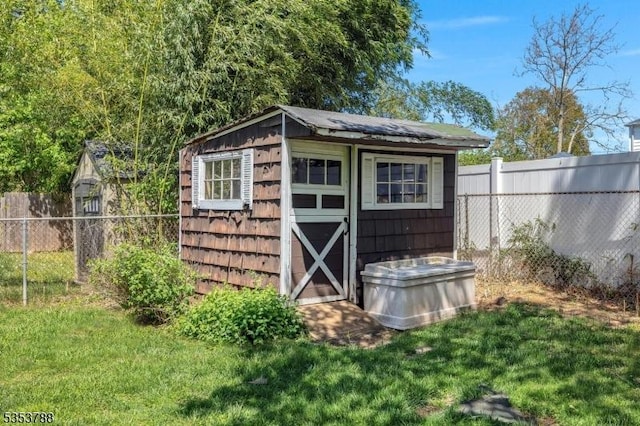 view of shed featuring fence