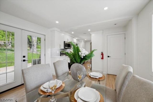 dining area featuring light wood-type flooring and recessed lighting