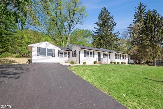 view of front of property featuring aphalt driveway and a front yard