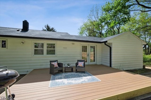 back of property with a chimney, outdoor lounge area, french doors, and a deck
