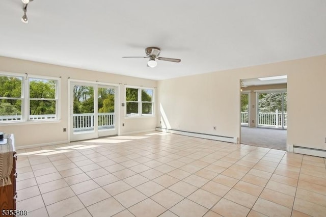 unfurnished room featuring a baseboard heating unit, a ceiling fan, healthy amount of natural light, and light tile patterned flooring