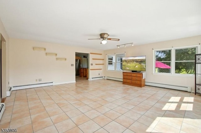 unfurnished room featuring baseboard heating, a baseboard heating unit, light tile patterned floors, a ceiling fan, and healthy amount of natural light