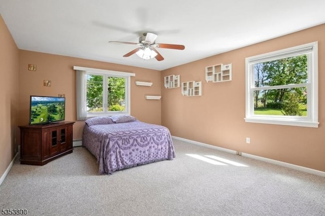 carpeted bedroom with baseboards, a wall unit AC, ceiling fan, and a baseboard heating unit