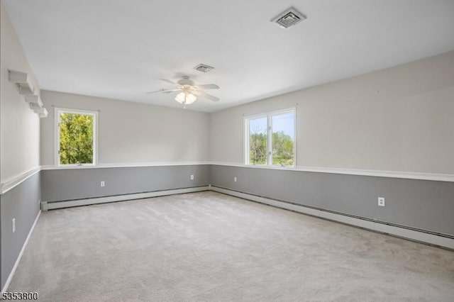 carpeted spare room featuring ceiling fan, healthy amount of natural light, baseboards, and baseboard heating