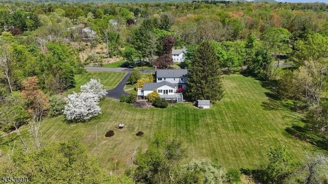 view from above of property with a heavily wooded area