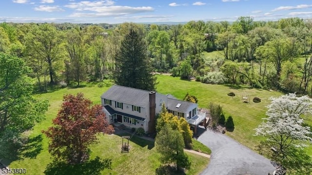 view of subject property featuring a forest