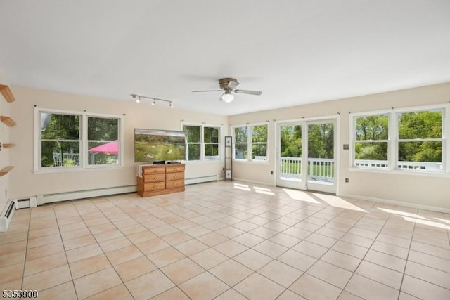 unfurnished sunroom with baseboard heating and rail lighting