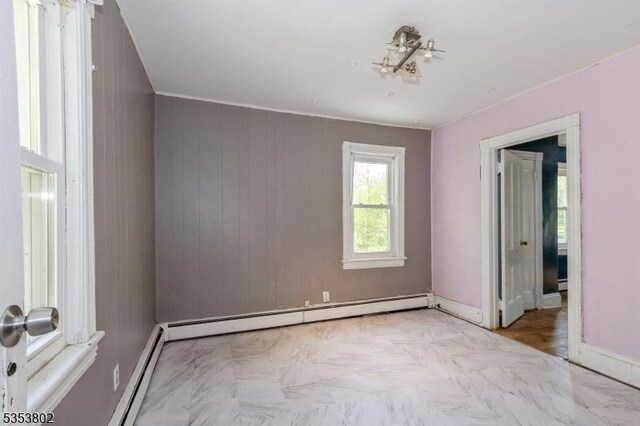 590 Valley Rd, Long Hill Twp, NJ 07933 - unfurnished bedroom featuring a baseboard heating unit, baseboards, a baseboard radiator, and crown molding