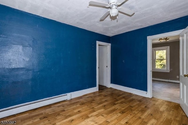 590 Valley Rd, Long Hill Twp, NJ 07933 - empty room featuring wood finished floors, baseboards, a ceiling fan, and a baseboard heating unit