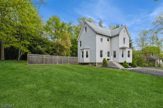 590 Valley Rd, Long Hill Twp, NJ 07933 - view of home's exterior with fence, a chimney, and a lawn