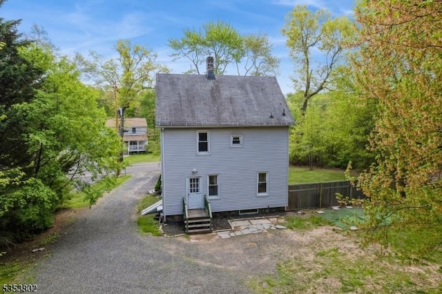 590 Valley Rd, Long Hill Twp, NJ 07933 - back of house featuring fence and a chimney