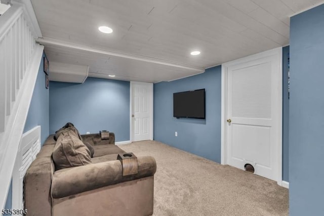 carpeted living area featuring recessed lighting and stairway