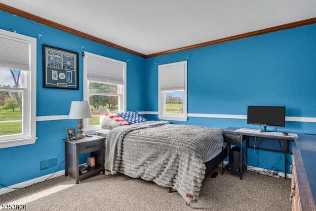 carpeted bedroom with crown molding, baseboards, and visible vents