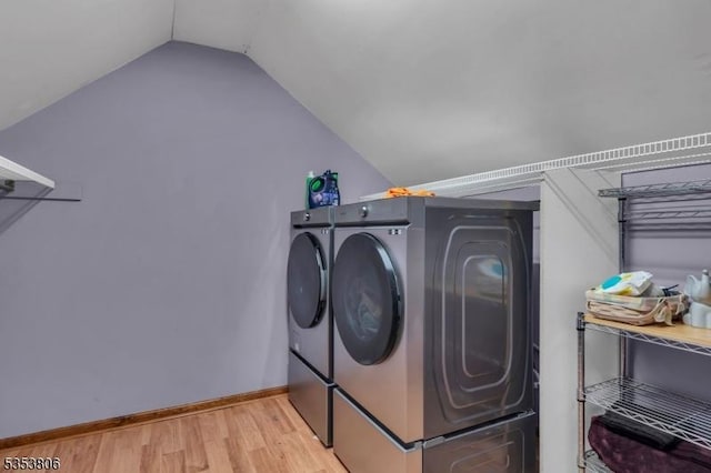 laundry area with separate washer and dryer, laundry area, baseboards, and light wood finished floors