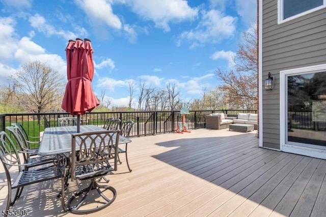 wooden deck with an outdoor hangout area and outdoor dining space