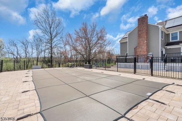 view of patio / terrace featuring a fenced in pool and fence