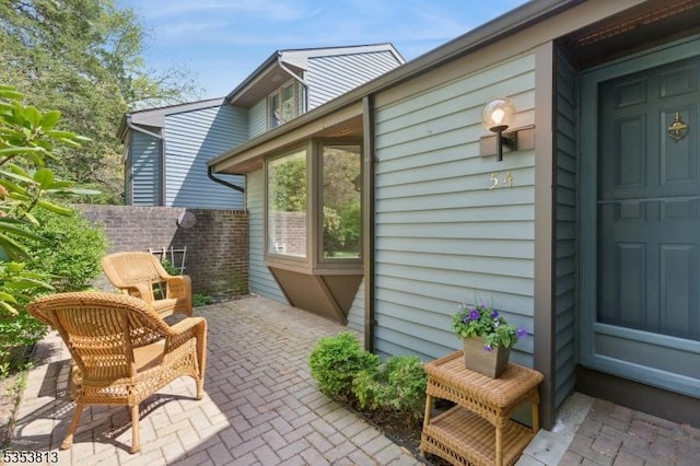 view of property exterior featuring a patio and fence