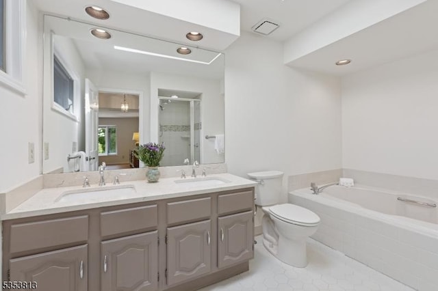 full bath featuring double vanity, tile patterned floors, a sink, and a stall shower