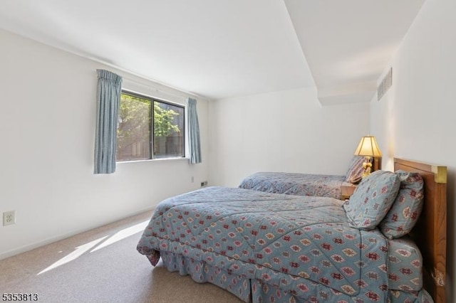 carpeted bedroom with baseboards and visible vents