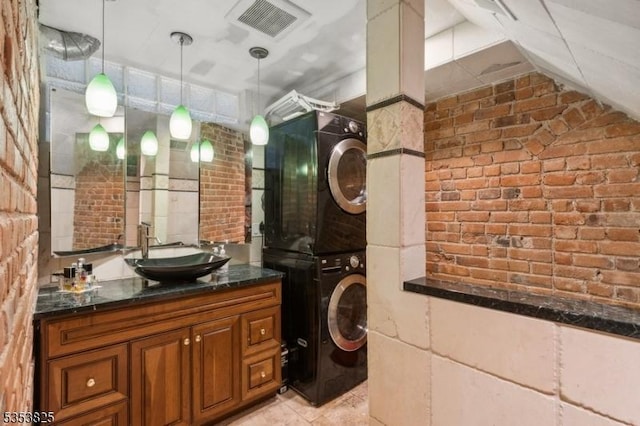 2 Perry St, Morristown Town, NJ 07960 - washroom featuring a sink, stacked washer and clothes dryer, brick wall, and visible vents