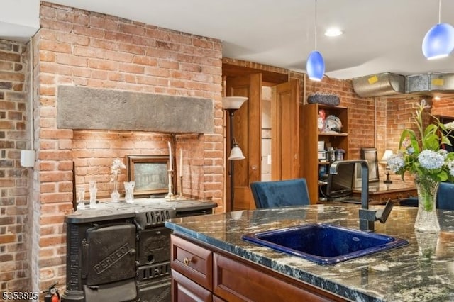 2 Perry St, Morristown Town, NJ 07960 - kitchen featuring dark stone countertops, decorative light fixtures, brick wall, and a sink