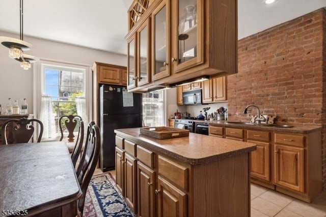 2 Perry St, Morristown Town, NJ 07960 - kitchen with glass insert cabinets, brown cabinetry, black appliances, a kitchen island, and dark countertops