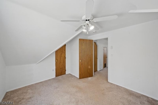 additional living space with ceiling fan, light carpet, and lofted ceiling